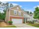 Charming two-story home with a well-manicured lawn, a two-car garage, and a welcoming front entrance at 728 Lorimore Pass, Canton, GA 30115