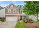 Charming two-story home with a well-manicured lawn, a two-car garage, and a welcoming front entrance at 728 Lorimore Pass, Canton, GA 30115