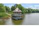 Charming two-story gazebo offers a scenic view of the lake and lush greenery at 728 Lorimore Pass, Canton, GA 30115