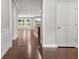 Inviting home hallway with gleaming hardwood floors, neutral walls, and decorative white trim at 728 Lorimore Pass, Canton, GA 30115