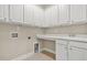 Laundry room equipped with ample cabinet space, a sink, and folding counter at 728 Lorimore Pass, Canton, GA 30115