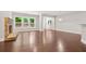 Open living space featuring hardwood floors, a stone fireplace, neutral walls, and large windows overlooking the backyard at 728 Lorimore Pass, Canton, GA 30115