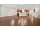 Spacious open-concept living area with hardwood floors, view of the kitchen, and stairs leading to the second floor at 728 Lorimore Pass, Canton, GA 30115