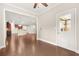 Open-concept living space with hardwood floors, a view of the kitchen, and a door leading to an outdoor area at 728 Lorimore Pass, Canton, GA 30115