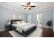 Staged main bedroom showcasing tray ceilings, hardwood floors, and stylish furnishings at 728 Lorimore Pass, Canton, GA 30115