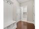 Well-organized mud room with a bench, hooks, storage, hardwood floors, and access to the laundry room at 728 Lorimore Pass, Canton, GA 30115