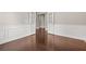 Open room with hardwood floors, decorative wainscotting, and natural light from French doors at 728 Lorimore Pass, Canton, GA 30115