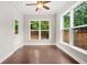 Cozy sunroom with bright windows, a ceiling fan, and an exterior door at 728 Lorimore Pass, Canton, GA 30115