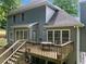 Exterior view showcasing a two-story house with a wooden deck and backyard at 1440 Boundary Blvd, Suwanee, GA 30024