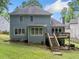 Backyard of a two-story house featuring a deck and staircase at 1440 Boundary Blvd, Suwanee, GA 30024