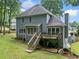 Back exterior view showcasing a spacious backyard, deck, and two-story home at 1440 Boundary Blvd, Suwanee, GA 30024