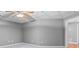Spacious basement with a ceiling fan, neutral walls and carpet ready to be finished for extra living space at 1440 Boundary Blvd, Suwanee, GA 30024