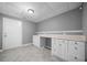 Basement area with tile floor, cabinetry and countertop space at 1440 Boundary Blvd, Suwanee, GA 30024