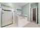 Bathroom features white tile, a large window, a walk-in shower, and a soaking tub at 1440 Boundary Blvd, Suwanee, GA 30024
