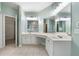 This bathroom features a double vanity, large mirrors, and tile floors at 1440 Boundary Blvd, Suwanee, GA 30024