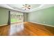 Bright bedroom with tray ceilings, hardwood floors, and a large window overlooking the backyard at 1440 Boundary Blvd, Suwanee, GA 30024