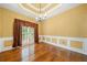 Traditional dining room features beautiful trim work, hardwood floors, and ample natural light at 1440 Boundary Blvd, Suwanee, GA 30024