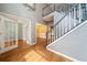 Welcoming foyer with hardwood floors, staircase, and elegant entryways to other rooms at 1440 Boundary Blvd, Suwanee, GA 30024