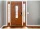 Elegant wooden front door featuring decorative glass sidelights and panels at 1440 Boundary Blvd, Suwanee, GA 30024