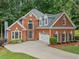 Attractive two-story brick home with an attached two-car garage, landscaped front yard, and a cozy curb appeal at 1440 Boundary Blvd, Suwanee, GA 30024