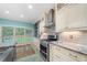 Modern kitchen boasts stainless steel appliances, granite countertops, and ample cabinet space at 1440 Boundary Blvd, Suwanee, GA 30024
