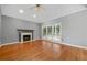 Living room with fireplace, vaulted ceiling, and large window with views of the backyard at 1440 Boundary Blvd, Suwanee, GA 30024