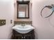 Cozy powder room boasting a decorative mirror and mosaic tile backsplash at 1440 Boundary Blvd, Suwanee, GA 30024