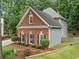 Beautiful home with brick and gray siding, manicured shrubs, and dark blue shutters at 1440 Boundary Blvd, Suwanee, GA 30024