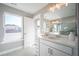 Clean and modern bathroom featuring a white vanity, marble floors, and a large window at 1741 Prospect Way, Conyers, GA 30094