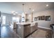 Open-concept kitchen boasts stainless appliances and a central island with views of the living area at 1741 Prospect Way, Conyers, GA 30094