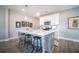 Well-lit kitchen featuring an island with barstool seating, white cabinets, and modern appliances at 1741 Prospect Way, Conyers, GA 30094