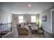 Comfortable living room featuring a plush sectional sofa, neutral decor, and plenty of natural light at 1741 Prospect Way, Conyers, GA 30094