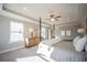 Bright main bedroom with large windows, tray ceilings, and a cozy four-poster bed at 1741 Prospect Way, Conyers, GA 30094
