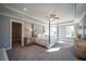 Spacious main bedroom with a four-poster bed, tray ceiling, and ample natural light at 1741 Prospect Way, Conyers, GA 30094
