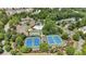 Aerial view of community amenities showcasing tennis courts, basketball court, clubhouse, pool, and green landscaping at 2205 Hoskin Nw Ct # 9, Kennesaw, GA 30144