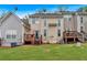 Townhome backyard with wooden decks, a grassy lawn, and exterior AC units for each unit at 2205 Hoskin Nw Ct # 9, Kennesaw, GA 30144