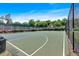 The community basketball court with green and blue painted court surface, surrounded by mature trees at 2205 Hoskin Nw Ct # 9, Kennesaw, GA 30144