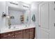 Bathroom featuring double sinks, a large mirror, dark cabinets, and modern lighting fixtures at 2205 Hoskin Nw Ct # 9, Kennesaw, GA 30144
