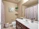Cozy bathroom featuring a vanity with storage, toilet, and shower with curtains, for a functional space at 2205 Hoskin Nw Ct # 9, Kennesaw, GA 30144