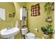 Charming bathroom with a pedestal sink, decorative mirror, and fresh decor, providing a relaxing and stylish space at 2205 Hoskin Nw Ct # 9, Kennesaw, GA 30144