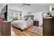 Bright bedroom with a queen bed, hardwood floors, ceiling fan and plenty of natural light at 2205 Hoskin Nw Ct # 9, Kennesaw, GA 30144
