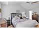 Bright bedroom with a queen bed, hardwood floors, ceiling fan and plenty of natural light at 2205 Hoskin Nw Ct # 9, Kennesaw, GA 30144