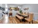 Inviting dining room features stylish wood floors, a rustic table, and bench seating for comfortable Gathering meals at 2205 Hoskin Nw Ct # 9, Kennesaw, GA 30144