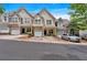View of the townhouse with stone accents, garage, and manicured landscaping in a well-kept neighborhood at 2205 Hoskin Nw Ct # 9, Kennesaw, GA 30144