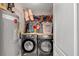 Laundry room with washer, dryer, water heater and shelves for storage and organization at 2205 Hoskin Nw Ct # 9, Kennesaw, GA 30144