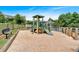 Community playground with a swing set, a slide, and a bench in a fenced-in, sandy area at 2205 Hoskin Nw Ct # 9, Kennesaw, GA 30144