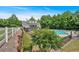 View of the community pool and clubhouse, framed by a white fence and lush greenery at 2205 Hoskin Nw Ct # 9, Kennesaw, GA 30144
