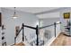 View of a staircase with wood steps, a white railing, and modern lighting fixtures at 2205 Hoskin Nw Ct # 9, Kennesaw, GA 30144