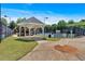 View of the community tennis courts and gazebo surrounded by lush trees and landscaping at 2205 Hoskin Nw Ct # 9, Kennesaw, GA 30144
