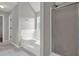 Bright bathroom with tiled floor features a separate shower and tiled soaking tub at 3885 Riverview Chase Blf, Ellenwood, GA 30294